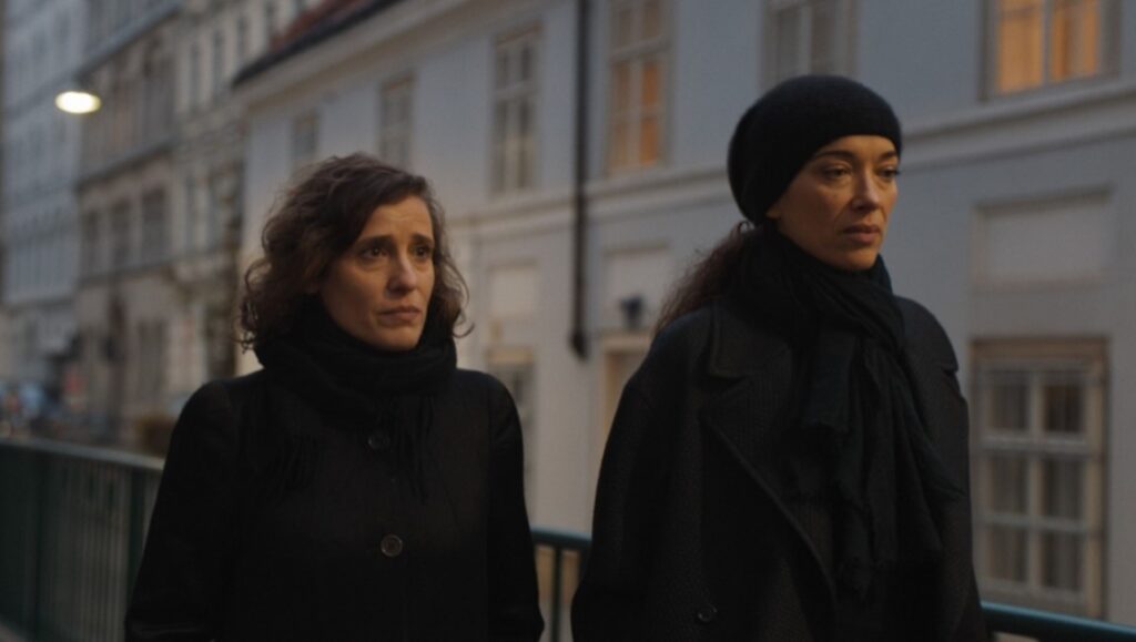 A Little Love Package — Gastón Solnicki A Little Love Package film still from the Berlin Film Festival 2022. Two women in dark coats.