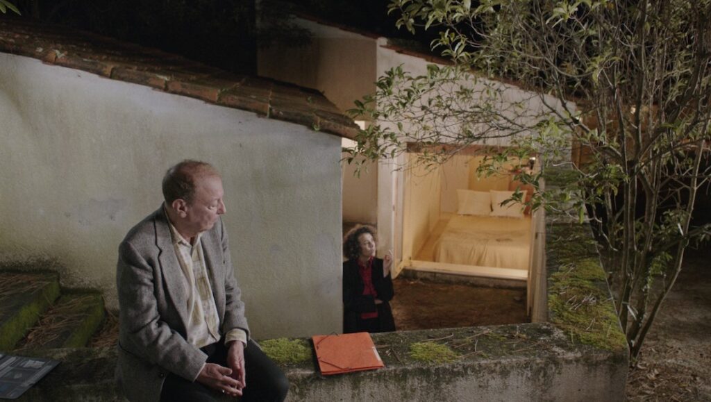 The Kegelstatt Trio — Rita Azevedo Gomes Rimini film still, Berlin Film Festival 2022. Man sitting outside, woman in doorway.