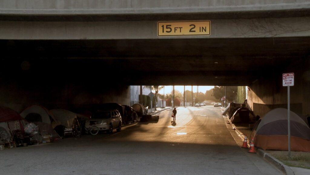 The United States of America film still: Homeless encampment under a bridge. Berlin Film Festival 2022.