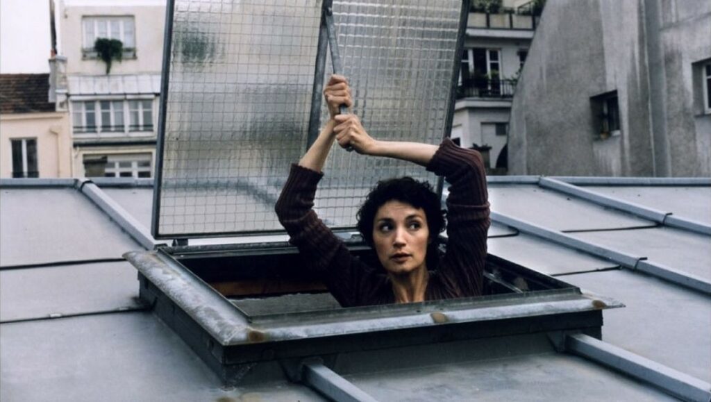 Sabine Azéma in Va Savoir by Jacques Rivette. Woman emerges from a rooftop window. French cinema.