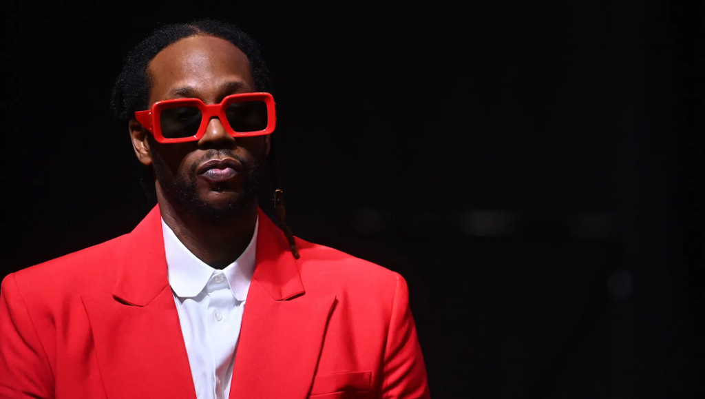 2 Chainz — Dope Don’t Sell Itself 2 Chainz promoting Dope Don't Sell Itself. Rapper in red suit and sunglasses.