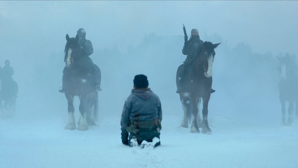 Black Crab — Adam Berg Black Crab film still: Soldiers on horseback in a snowy landscape, kneeling figure. Adam Berg film.