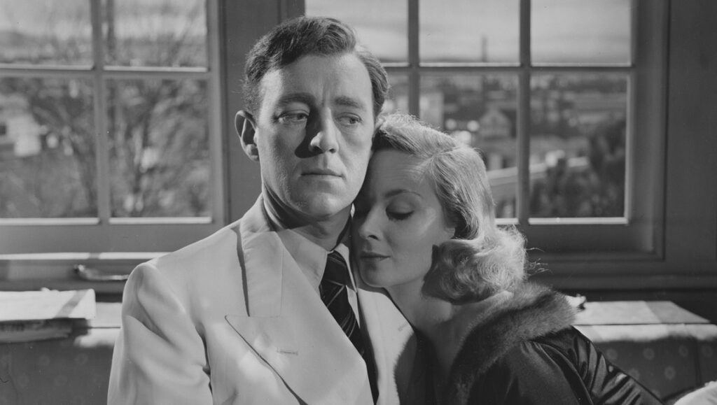 Still from The Man in the White Suit, featuring a man in a suit and a woman.