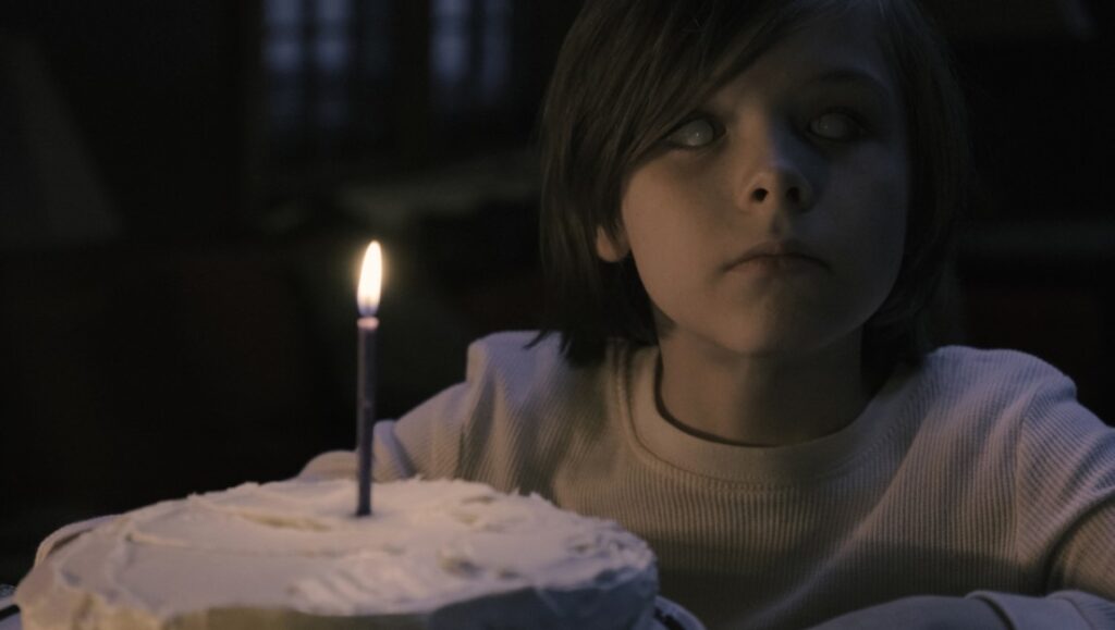 Before We Vanish blog image: Blind child with birthday cake and candle. Horror movie review.