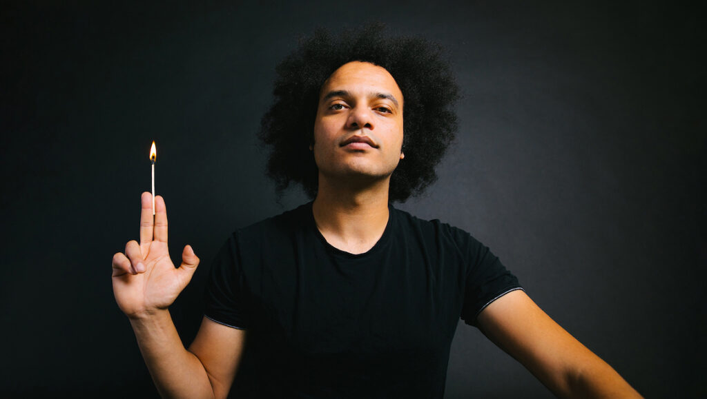 Zeal & Ardor — Zeal & Ardor Zeal & Ardor album art. Musician holding a lit match. February 2022 album roundup.