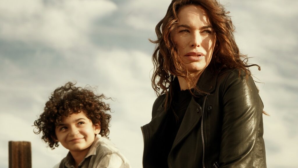 9 Bullets — Gigi Gaston Lena Headey in 9 Bullets movie. Woman in leather jacket with child. Action film scene.