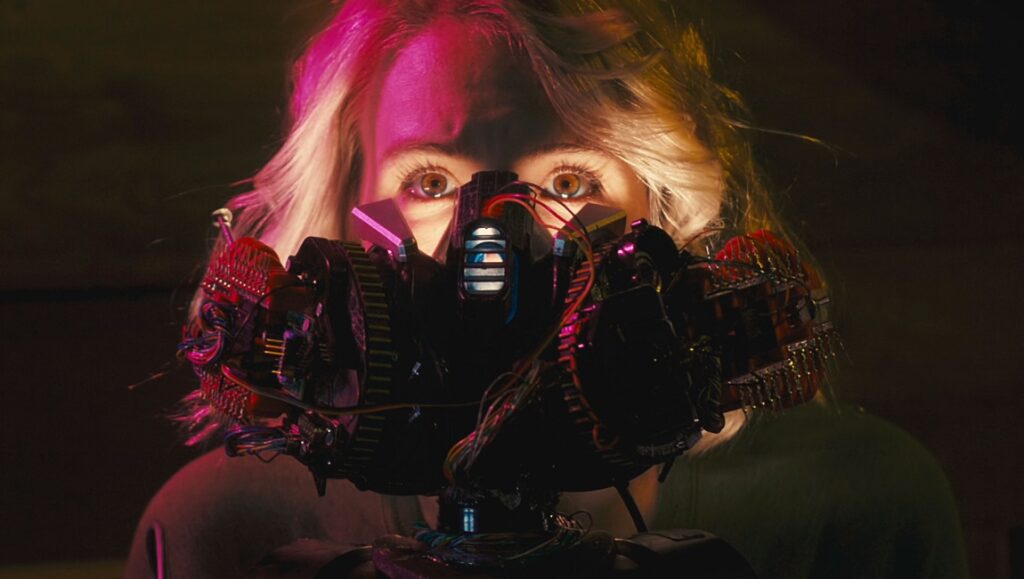 Madelines — Jason R. Miller Woman with futuristic tech mask. Cyberpunk style with exposed wires and circuit boards. Sci-fi concept.