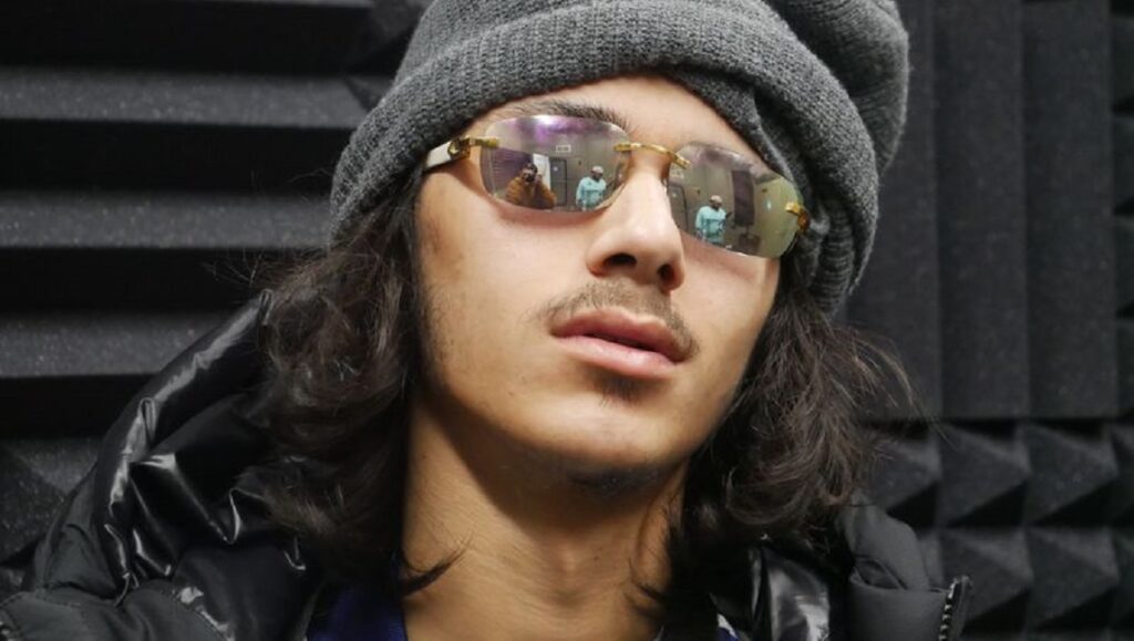 BabyTron — MEGATRON Babytron album review image. Rapper with beanie and sunglasses. March 2022 music roundup.