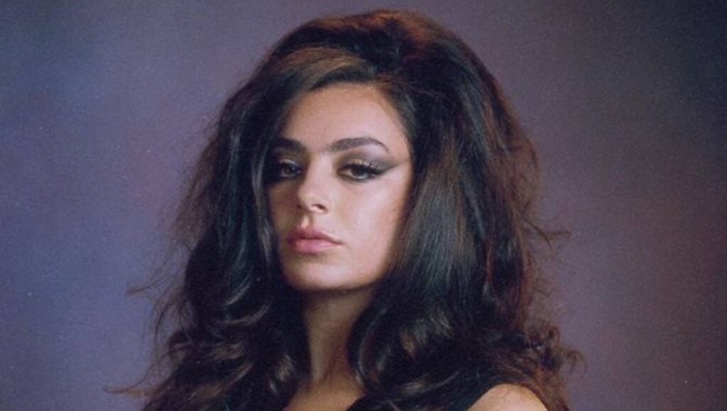 Charli XCX portrait. Album Roundup — March 2022 artist with dark hair and eye makeup.