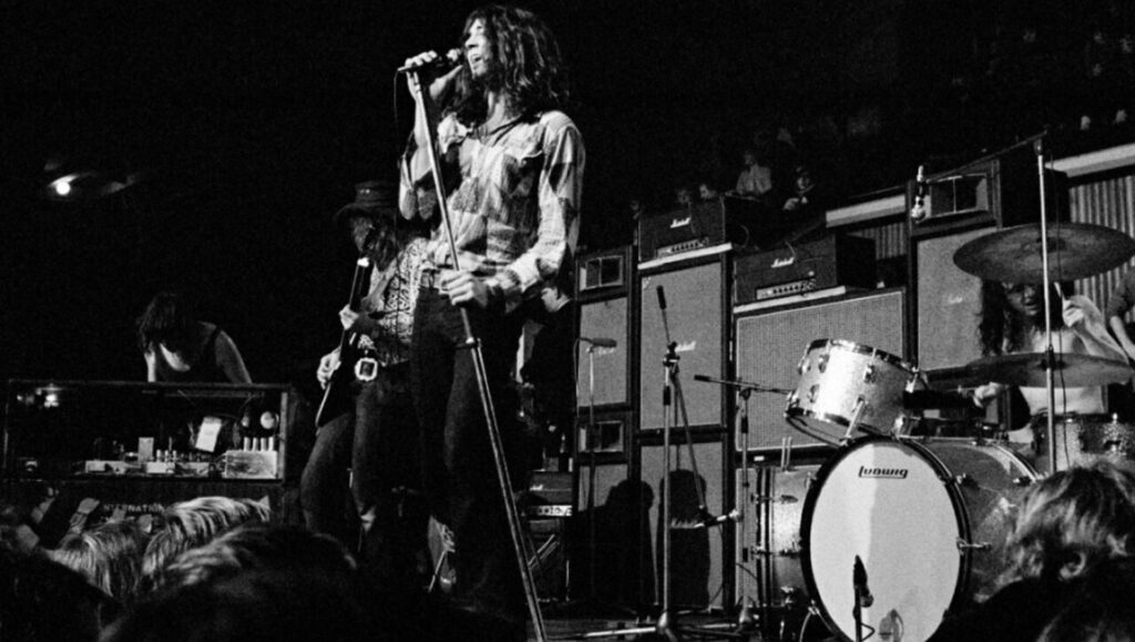Deep Purple performing Machine Head live in concert. Black and white image of the band on stage.