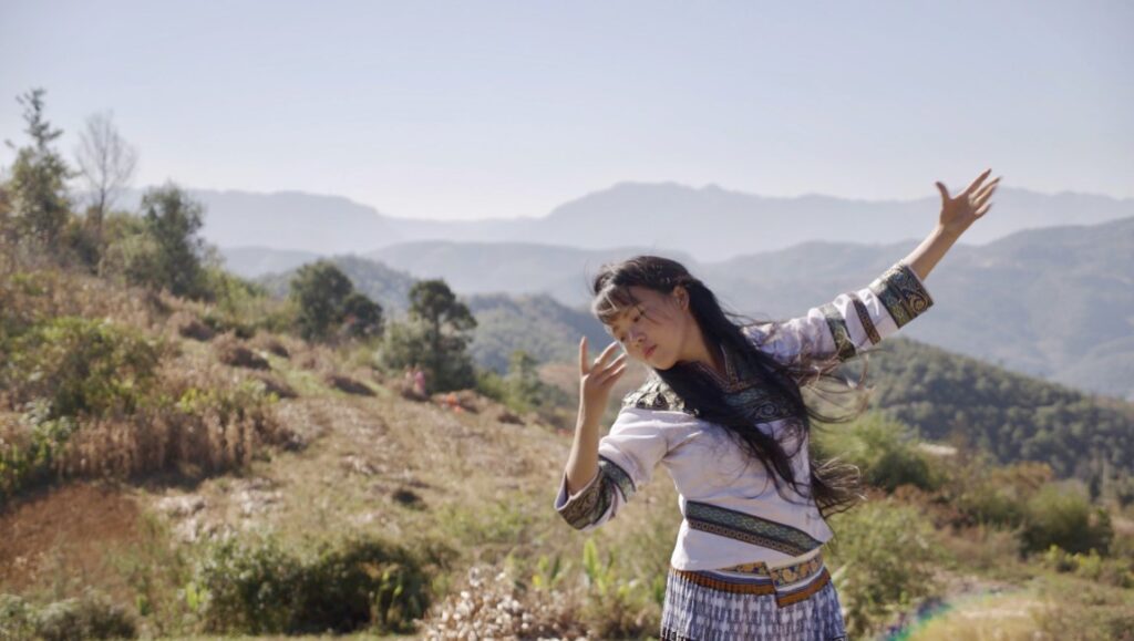 Singing in the Wilderness — Chen Dongnan Chen Dongnan's Singing in the Wilderness: Woman in traditional dress with mountains in background.