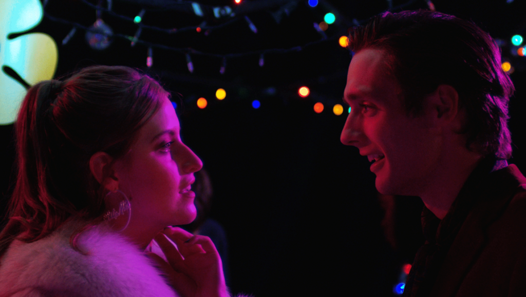 Before We Vanish — April 2022: The Sound of Violet, 9 Bullets, Hello, Bookstore Close-up of a man and woman facing each other under colorful lights. Sound of Violet movie scene.