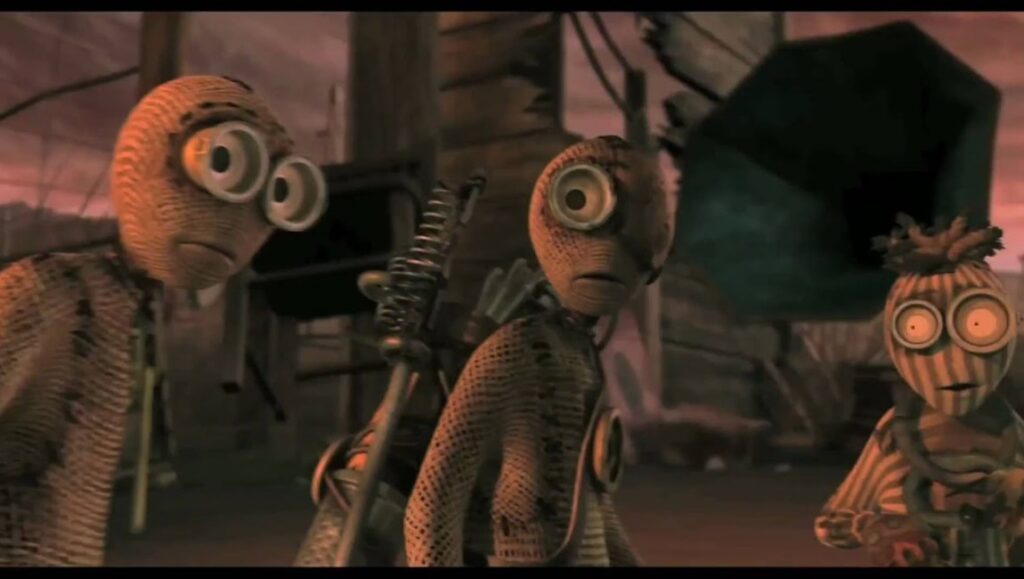 9 movie still. Three burlap sack characters with large eyes stand in a war-torn landscape. Shane Acker film.