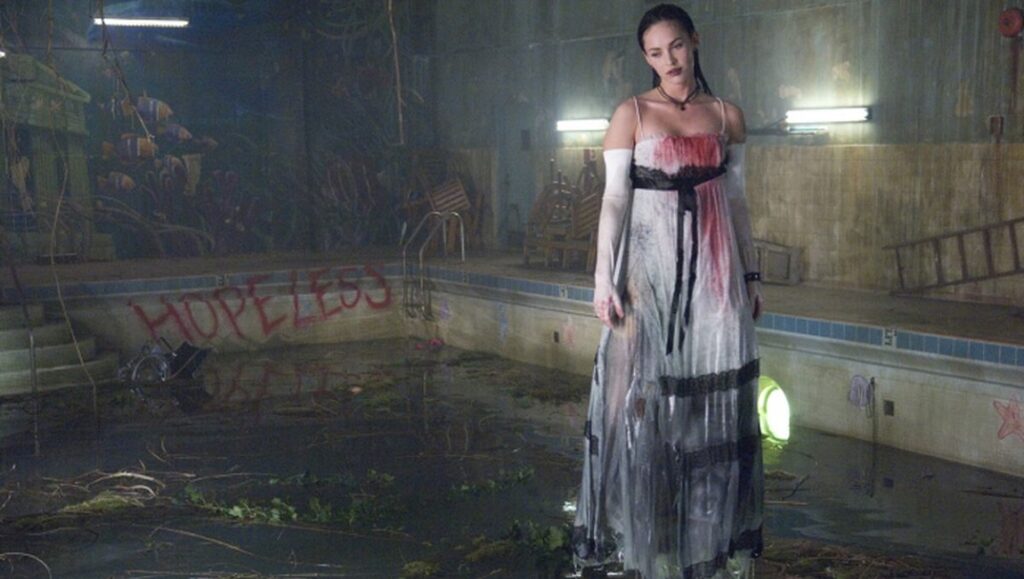 Megan Fox as Jennifer in Jennifer's Body. Karyn Kusama film scene with a drained pool and graffiti.