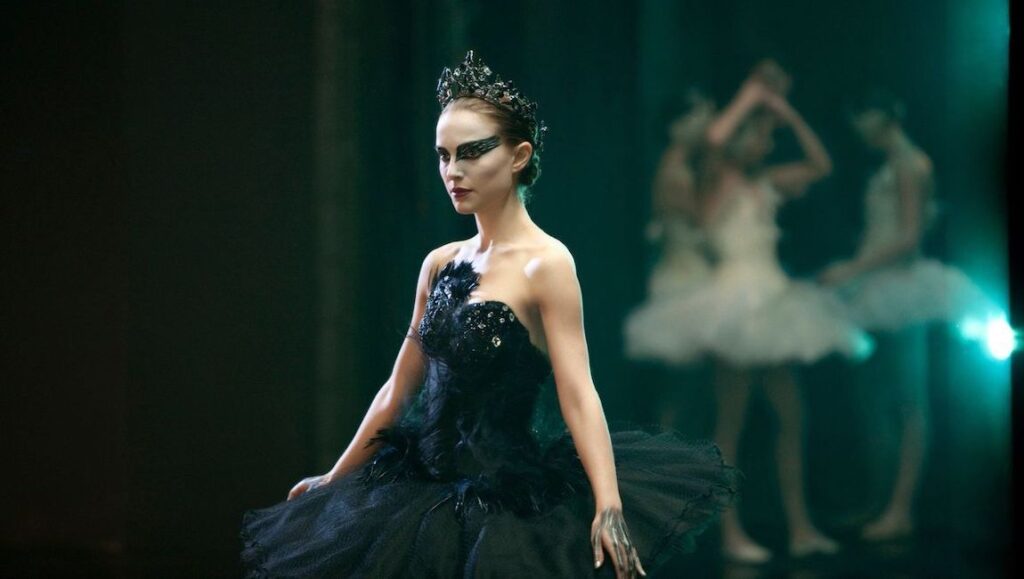 Black Swan — Darren Aronofsky Natalie Portman as the Black Swan. Ballerina in dark costume and crown. Ballet performance.