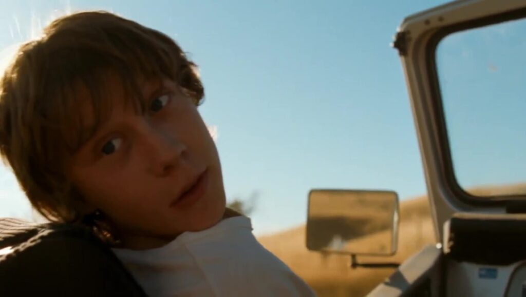 The Boys Are Back — Scott Hicks The Boys Are Back movie still. Young boy in car with blue sky. Scott Hicks film.