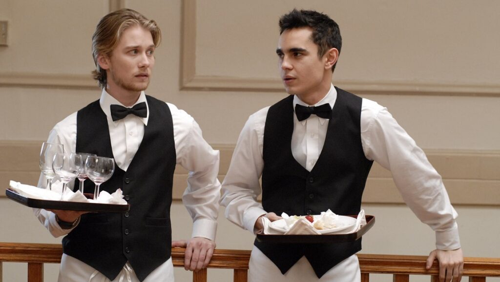 Bright Star film still: Two waiters in bow ties hold trays of drinks and desserts.