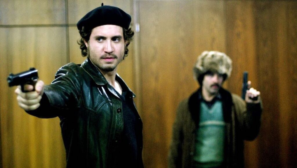 Two men holding guns. One wears a beret and leather jacket, the other a fur hat. Crime, action.