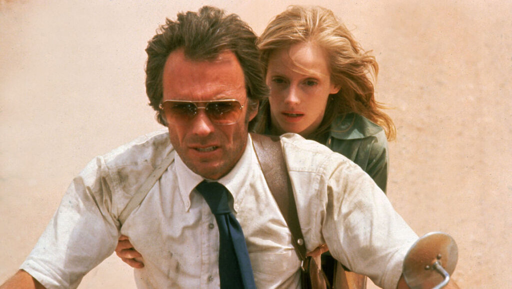 Clint Eastwood in action. Movie still of Eastwood with co-star. Flickers of style.