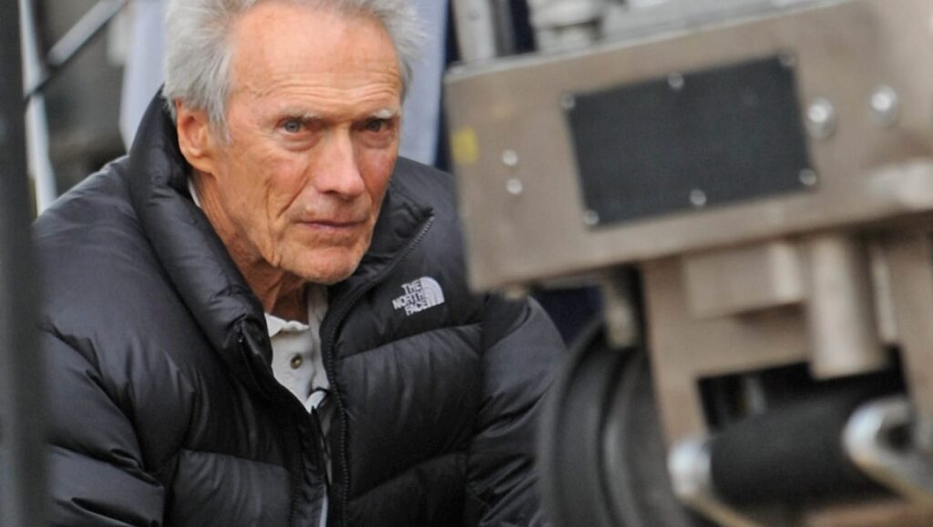 Clint Eastwood on set. The legendary actor and director in a candid moment. Film icon.