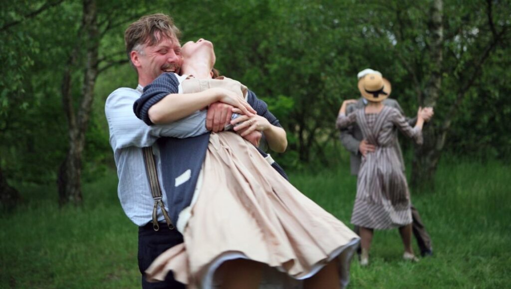 Waltz With Bashir film still. Couples waltzing in a field. Ari Folman film.