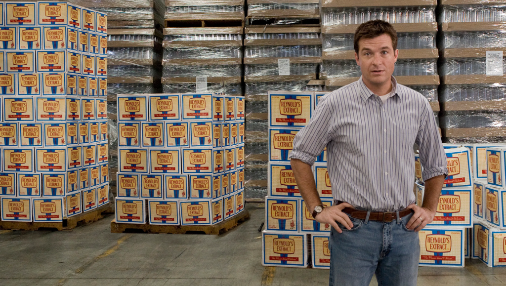 Extract — Mike Judge Jason Bateman in Extract movie, standing in a warehouse full of Reynolds Extract boxes.