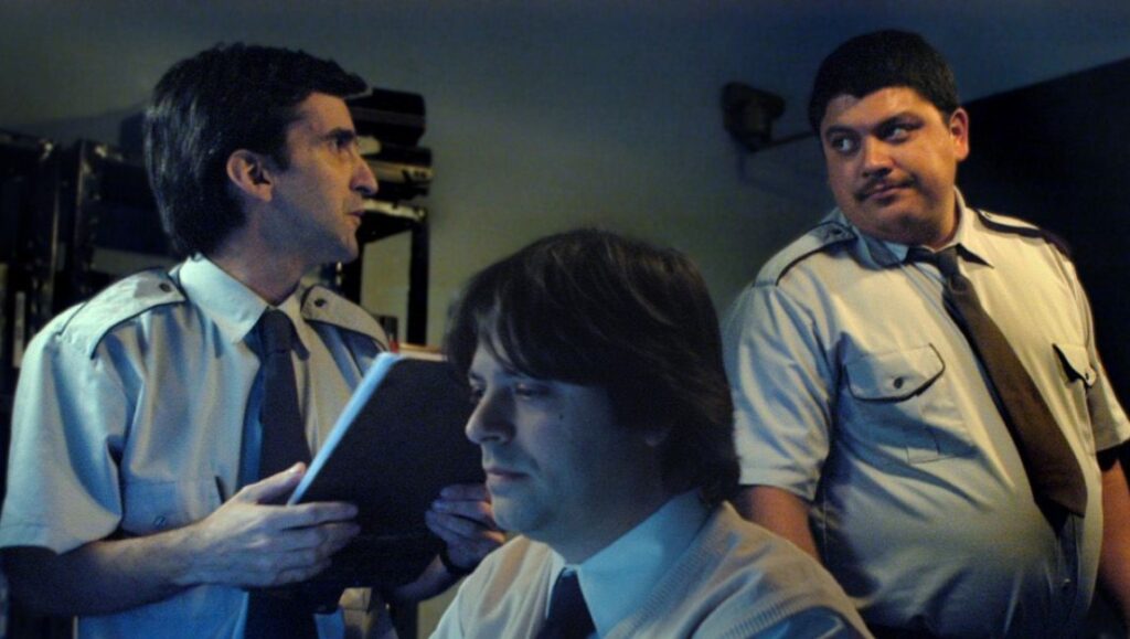 Three security guards in uniform. One holds a clipboard. Security staff.