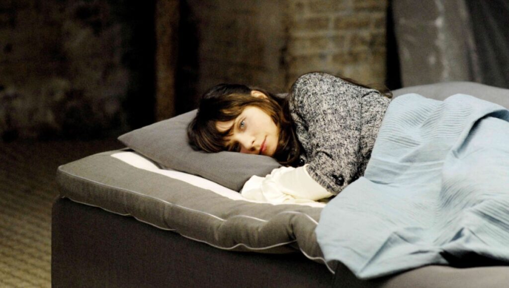 Waltz With Bashir still: Ari Folman film scene. Woman lying in bed. Movie still.