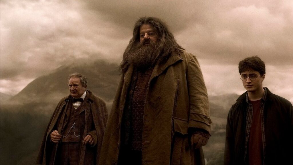 Harry Potter and the Half-Blood Prince — David Yates Harry Potter and the Half-Blood Prince scene with Harry, Dumbledore, and Hagrid against a cloudy sky.