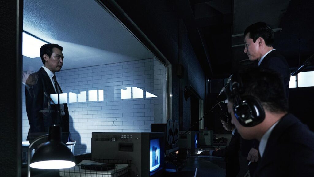 Lee Jung-jae in Hunt at Cannes Film Festival 2022. Men in suits in a dark control room.
