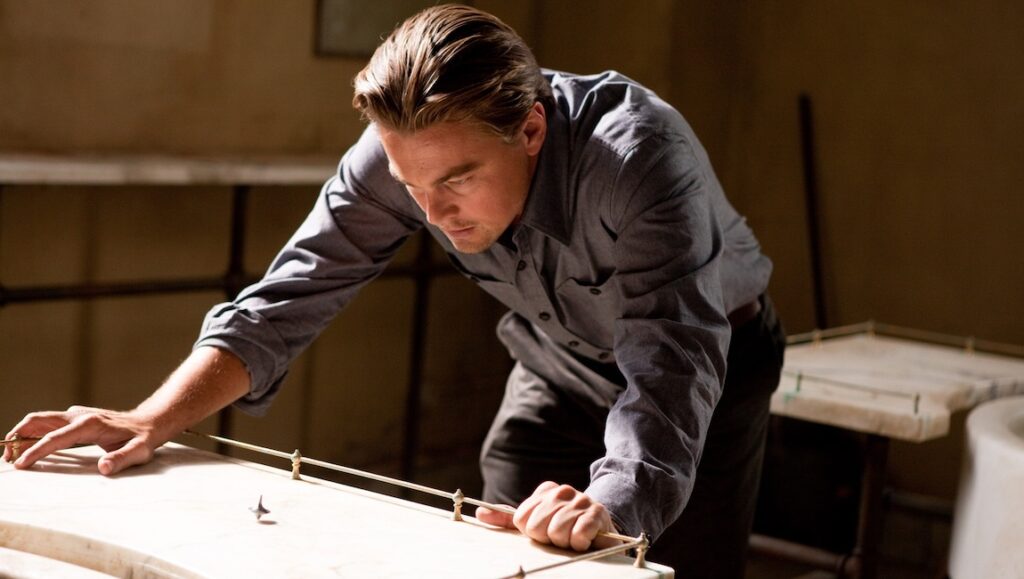 Leonardo DiCaprio in Inception. Dom Cobb with a spinning top. Movie scene.