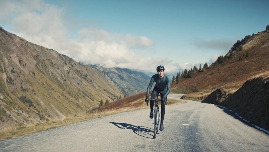 A cyclist rides on a mountain road. Outdoor sports, cycling, and mountain scenery.
