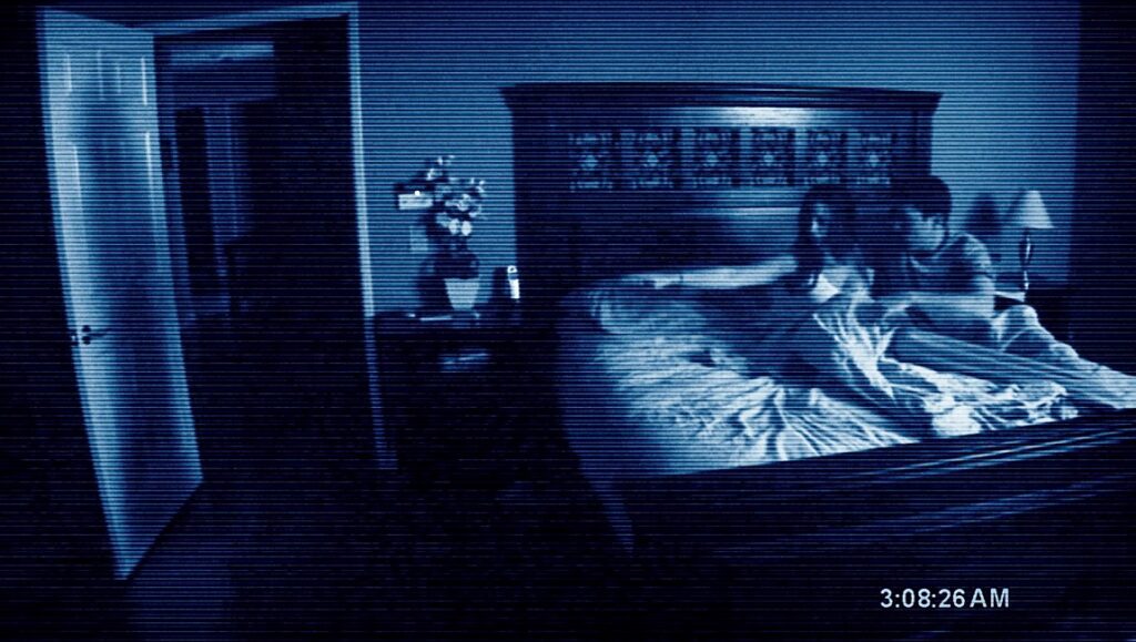 Paranormal Activity movie scene. Couple in bed, night vision effect.