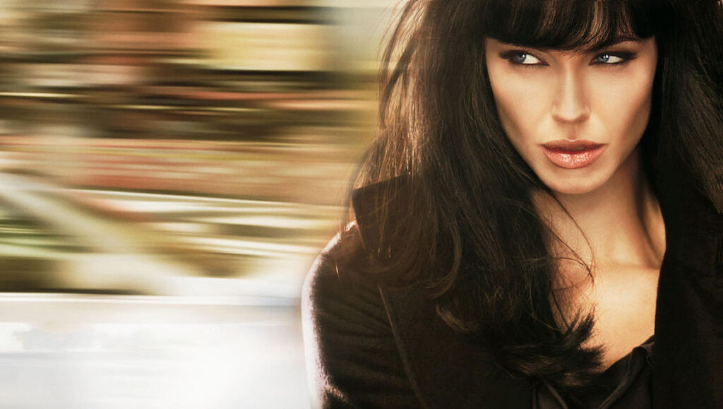 Angelina Jolie as Agent Salt. Movie still of a woman with dark hair and piercing blue eyes. Action film concept.