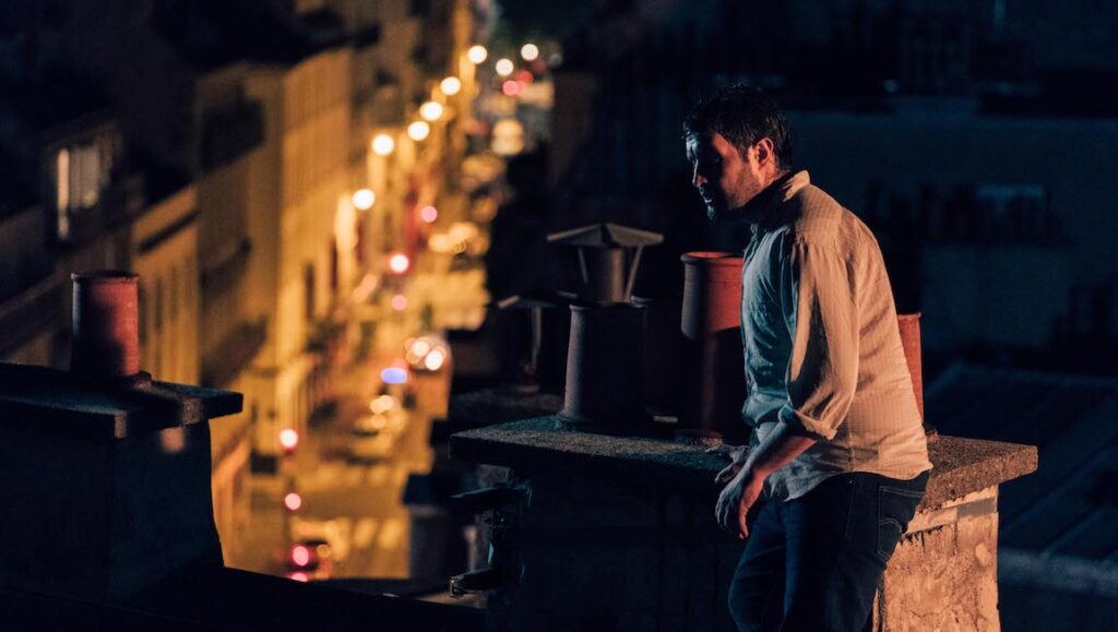 Sons of Ramses — Clement Cogitore Sons of Ramses film still from Cannes Film Festival. Man on rooftop at night.