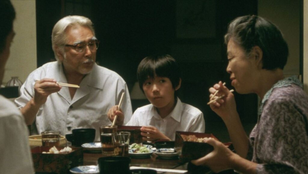 Still Walking — Hirokazu Kore-eda Still Walking film scene. Family dinner with parents, child, and food on the table. Japanese movie.