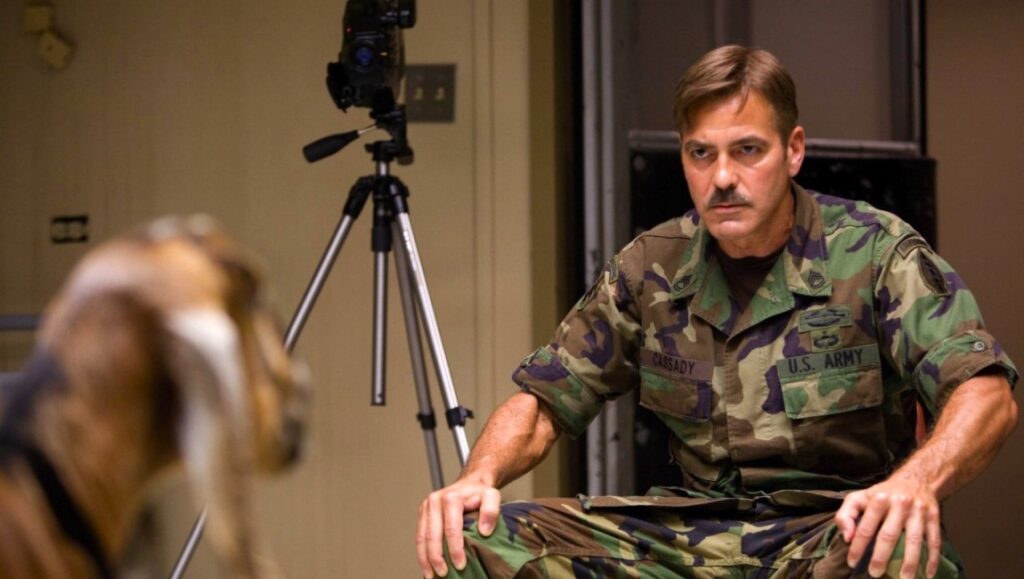 The Men Who Stare At Goats movie still: George Clooney in army uniform staring at a goat.