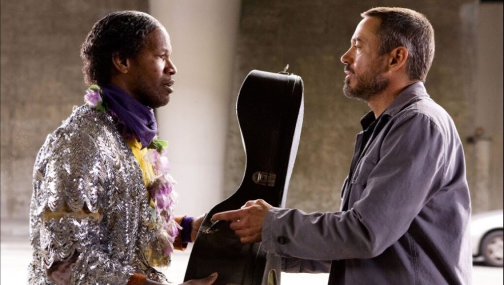 The Soloist — Joe Wright The Soloist movie scene: Jamie Foxx and Robert Downey Jr. with a guitar case.