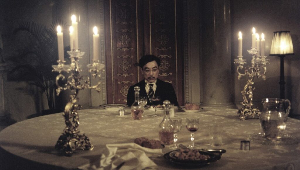 The Sun — Alexander Sokurov Still from The Sun film by Alexander Sokurov. Hirohito at dinner with candelabras and wine.