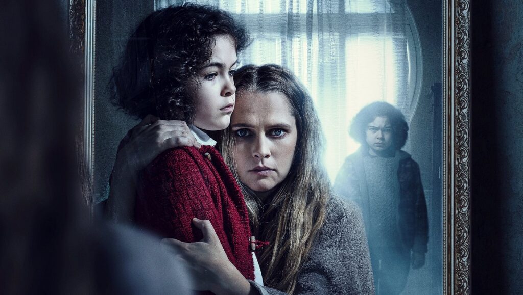 The Twin movie poster: A mother and child look anxiously at a ghostly twin in a mirror.