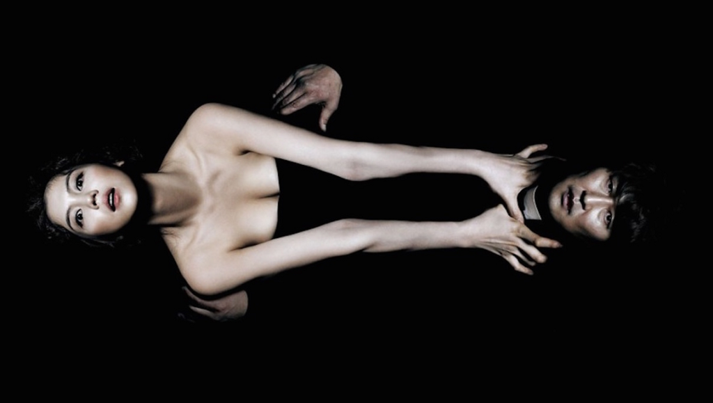 Thirst movie image: Woman and man on black background. Park Chan-wook film.