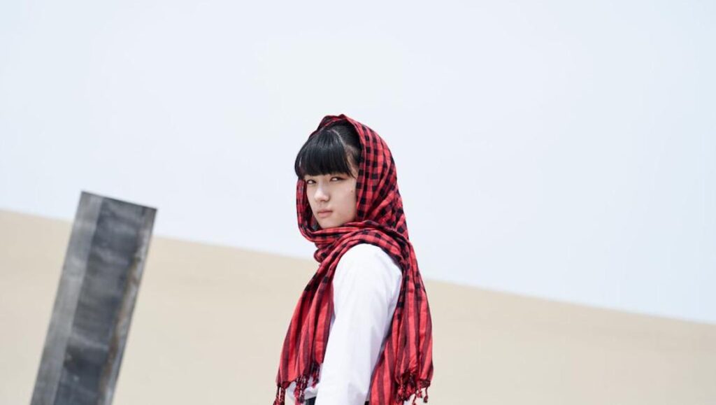 Yamabuki — Juichiro Yamasaki Yamabuki film still from Cannes Film Festival. Young woman in red scarf. Indie film.