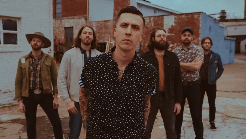 Americana Aquarium band photo. Group portrait of the Americana band in an urban outdoor setting. New music album roundup.