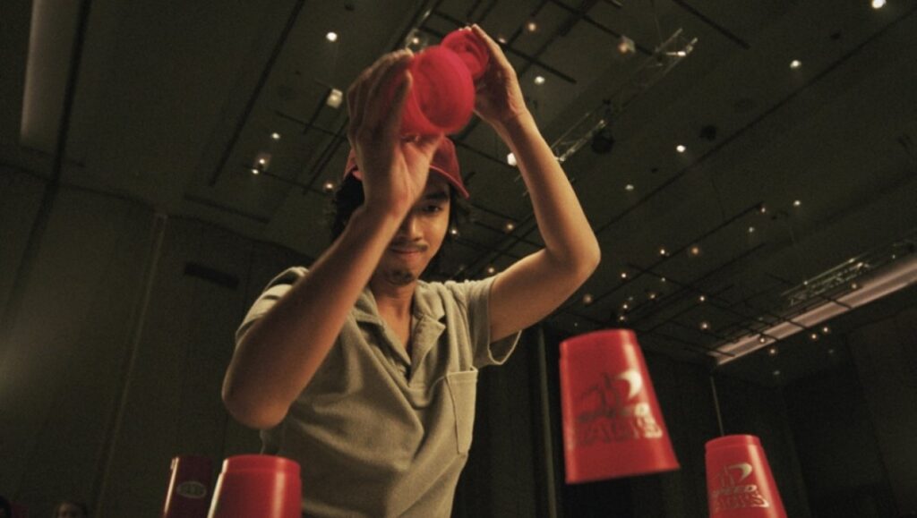NYAFF 2022: A man speed stacking red cups. Fast and Feel Love film review.