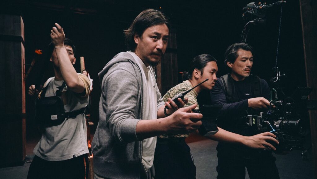 NYAFF 2022: Film crew in action. Director with walkie-talkie, camera operator, and assistant on set. Manchurian Tiger, Virgin Blue.