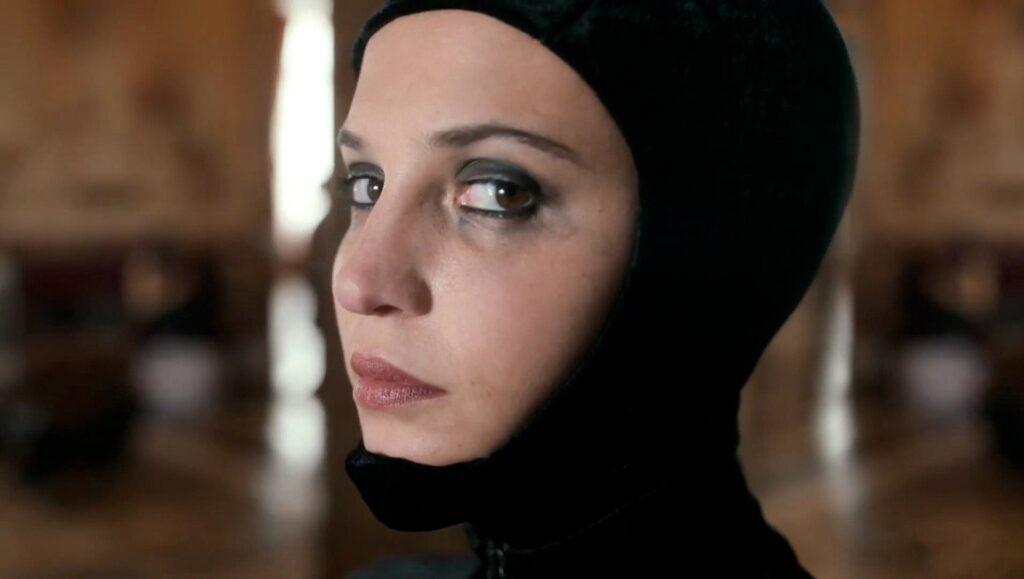 Irma Vep — Olivier Assayas: A Dialogue on Episode 8 Irma Vep, Olivier Assayas. Alicia Vikander as Irma Vep in the HBO series. Close-up of Vikander in black costume.