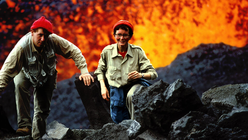Katia and Maurice Krafft, volcanologists, in The Fire Within at DOC NYC 2022. Volcano and lava background.