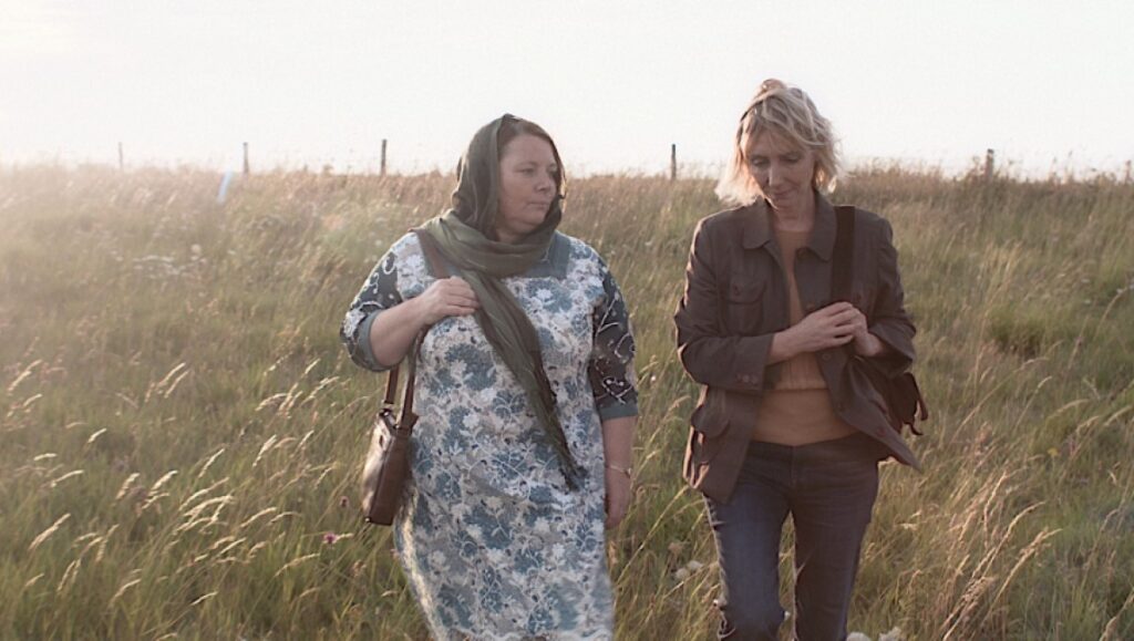 After Love movie still: Two women walk through a field. Aleem Khan film.