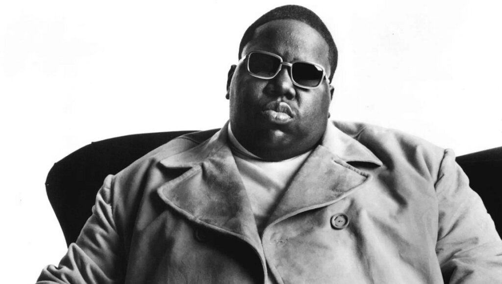 Notorious B.I.G. — Life After Death Black and white portrait of The Notorious B.I.G. wearing sunglasses and a coat. Rock and Roll Hall of Fame.