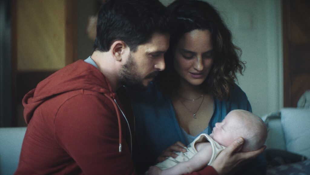 Parents with newborn baby. Mother and father holding infant. Family love and care.
